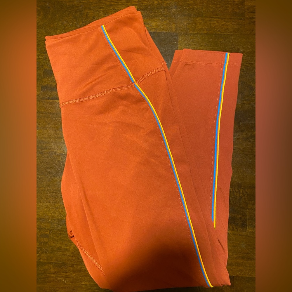 Nike Dri-Fit retro burnt orange leggings with blue and yellow stripes